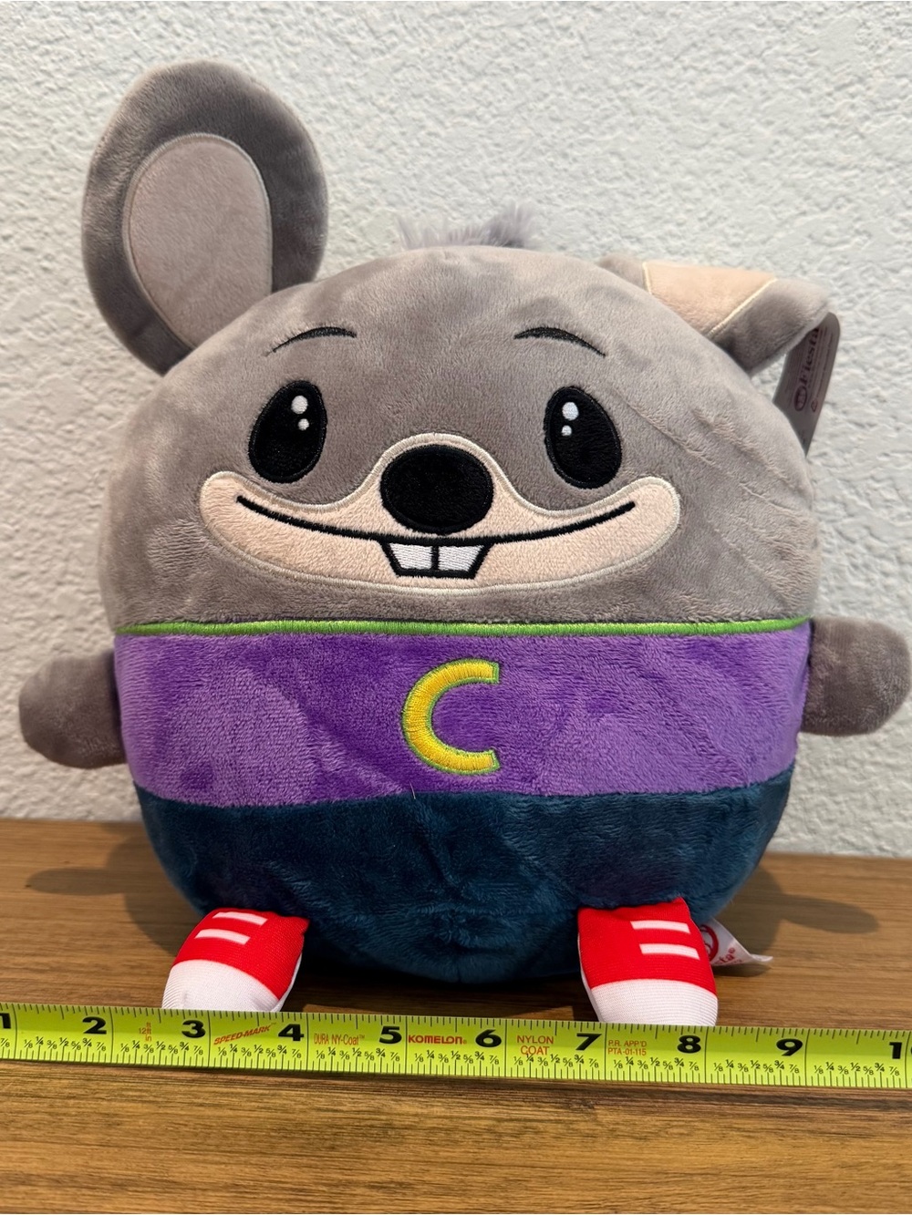 Gray Plush Character Toy with Purple Shirt and Yellow 'C'